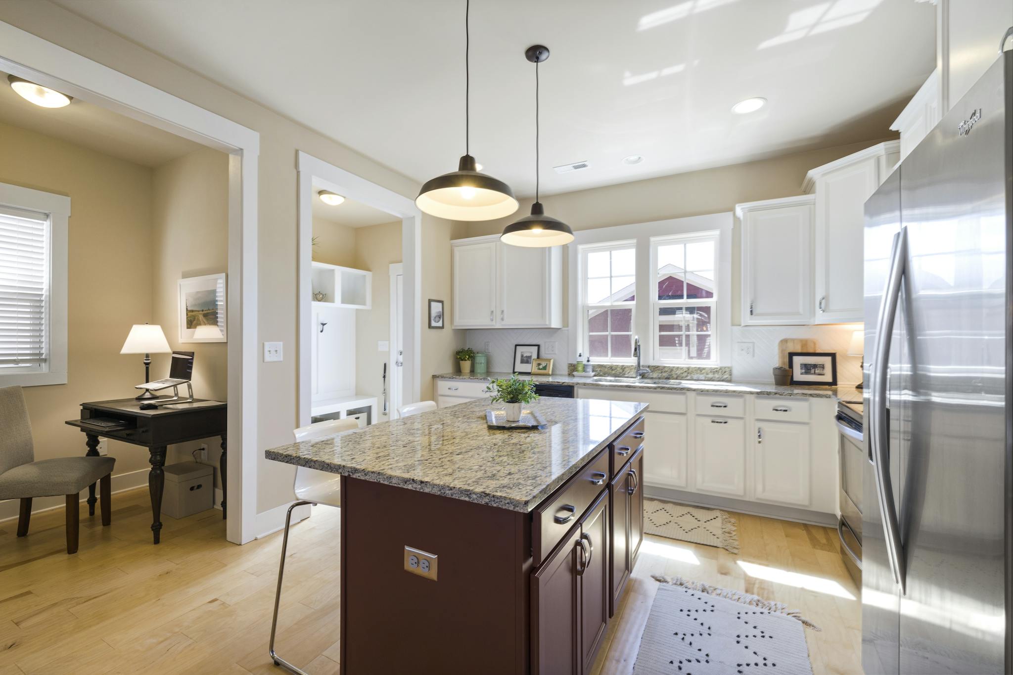 Bright and spacious kitchen interior with island and stainless steel appliances.