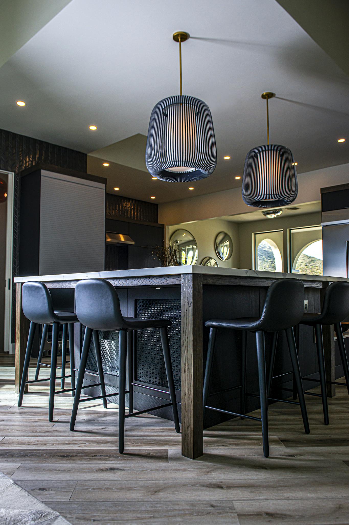 Stylish kitchen interior featuring pendant lighting above a central island.